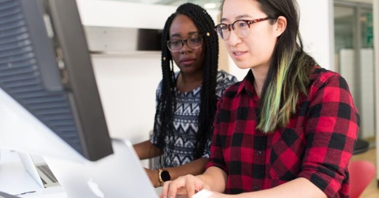 Software - Woman Wearing Red and Black Checkered Blouse Using Macbook