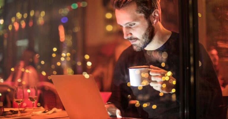 Laptop - Man Holding Mug in Front of Laptop